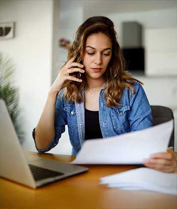 Woman on phone paying bills