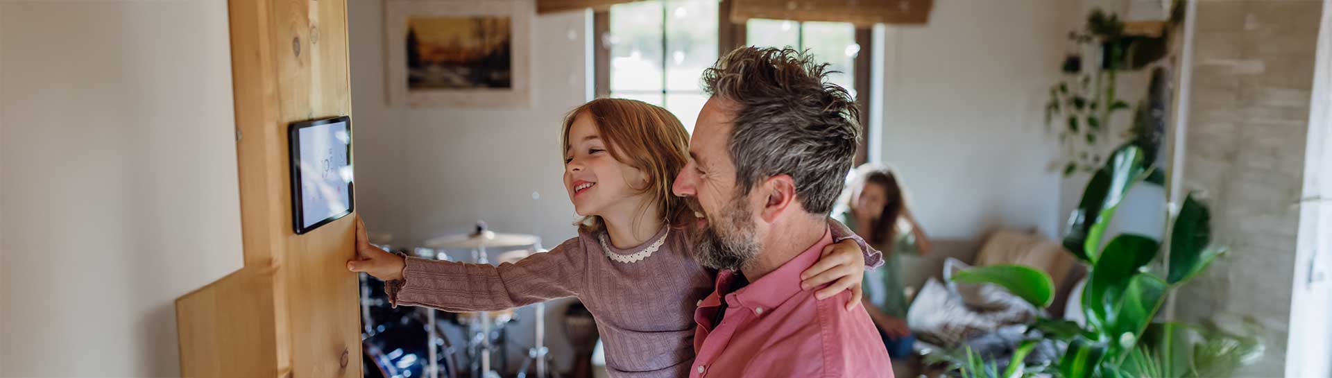 Father & daughter adjusting Wi-Fi thermostat